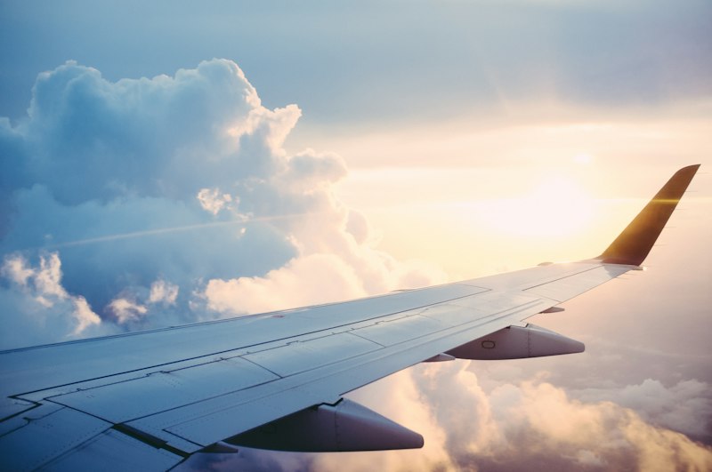 Airplane at dusk representing travel planning and booking timing